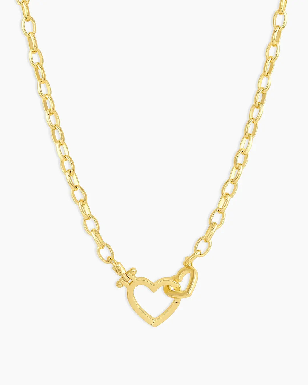 Gold necklace with a heart-shaped clasp on a white background