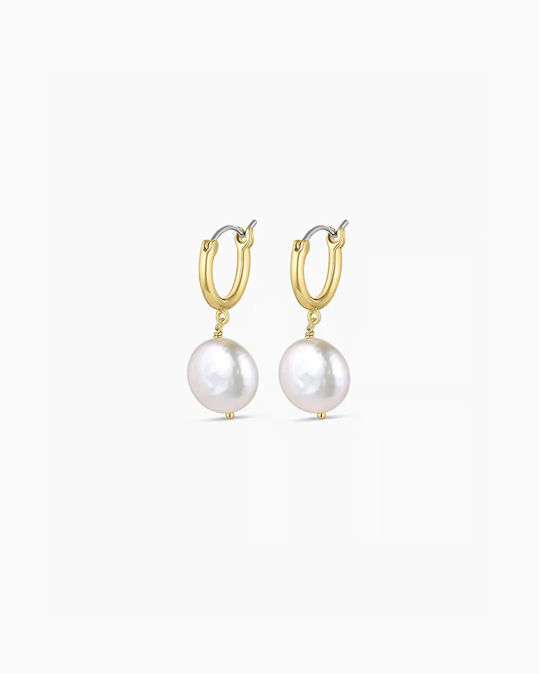 Gold hoop earrings with pearl drops on a white background