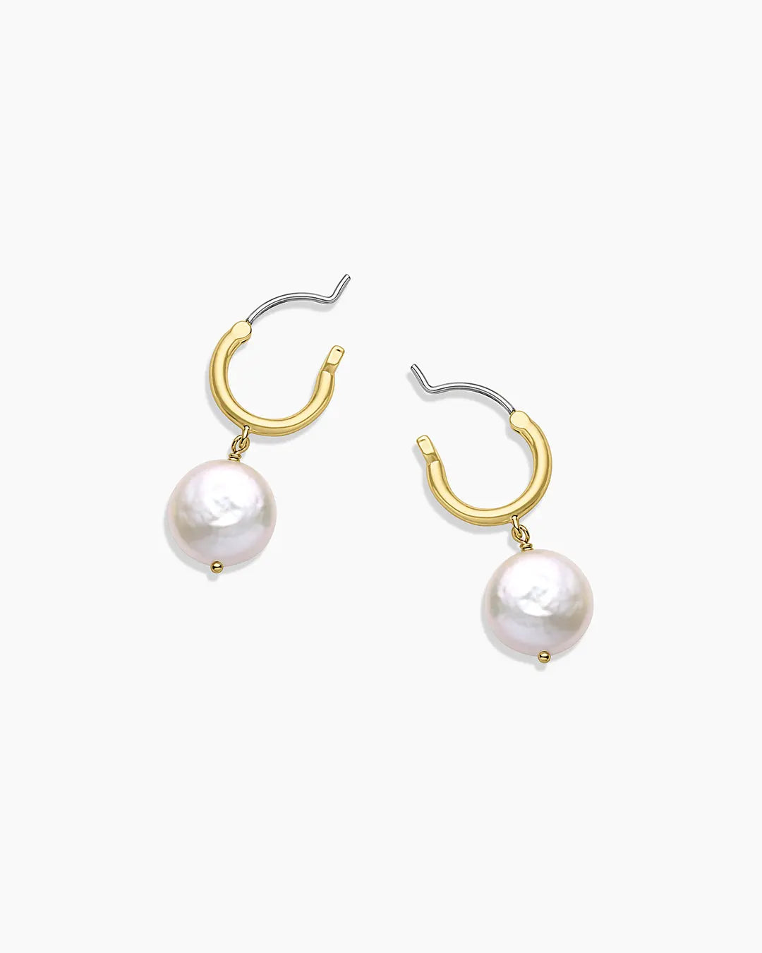 Gold hoop earrings with pearl drops on a white background