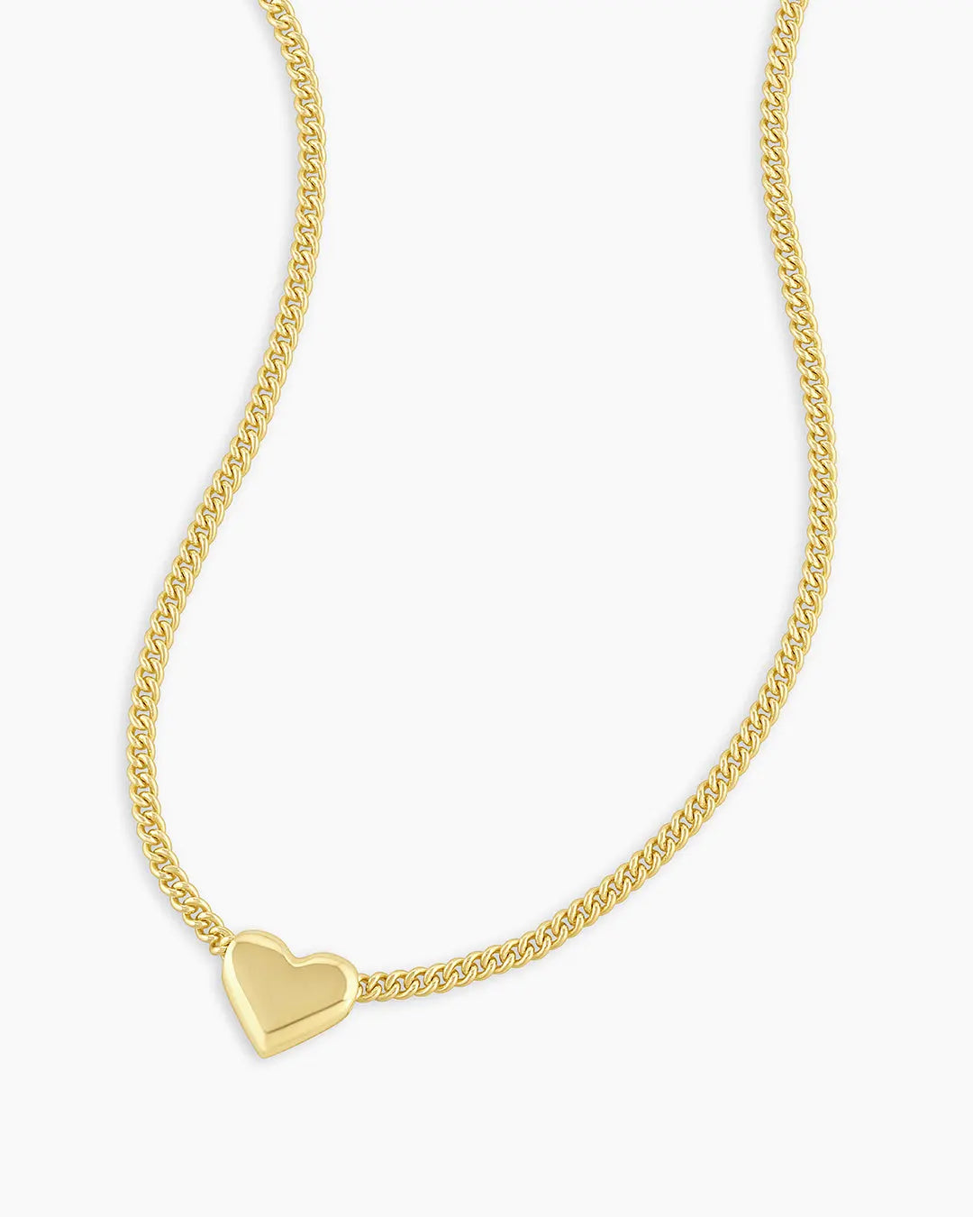 Gold heart-shaped pendant necklace on a white background