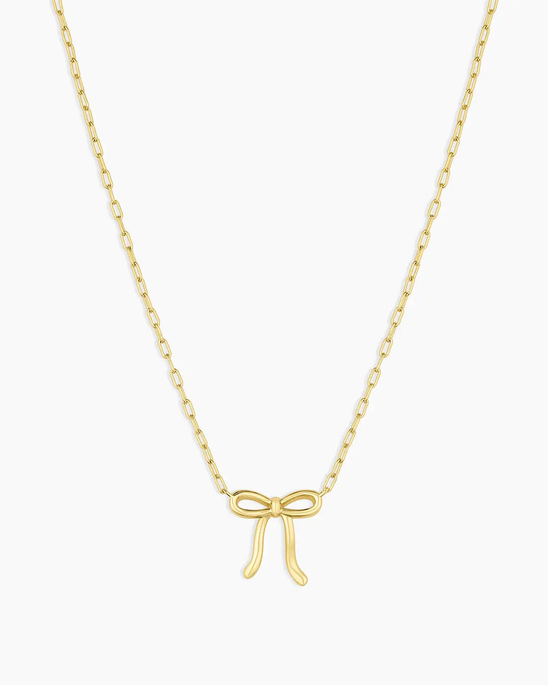 Gold bow-shaped pendant necklace on a white background