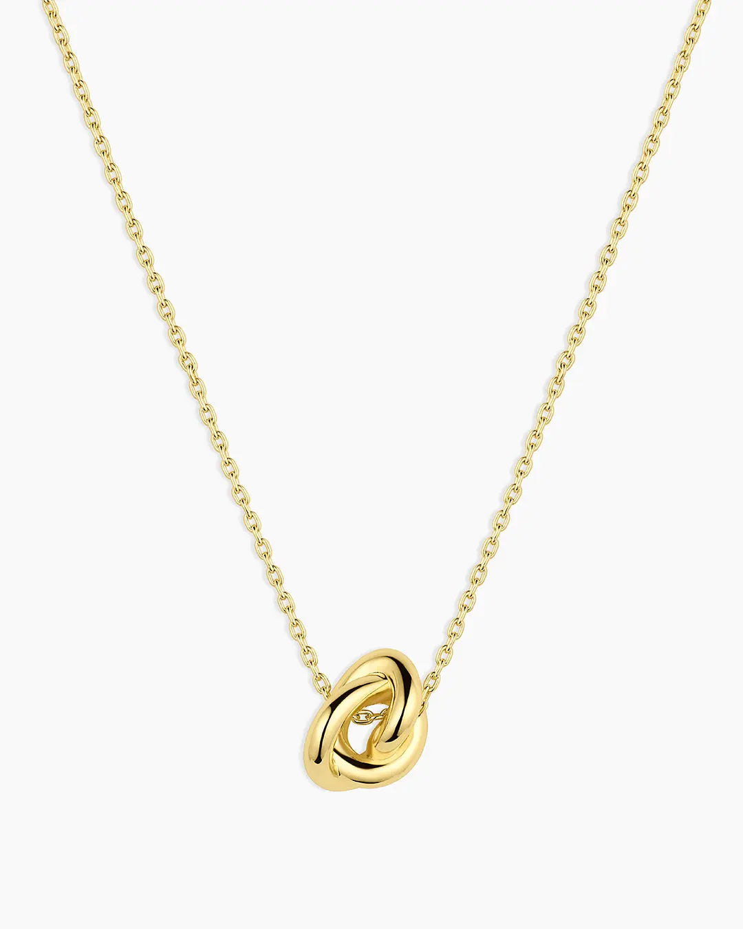 Gold necklace with a knot pendant on a white background