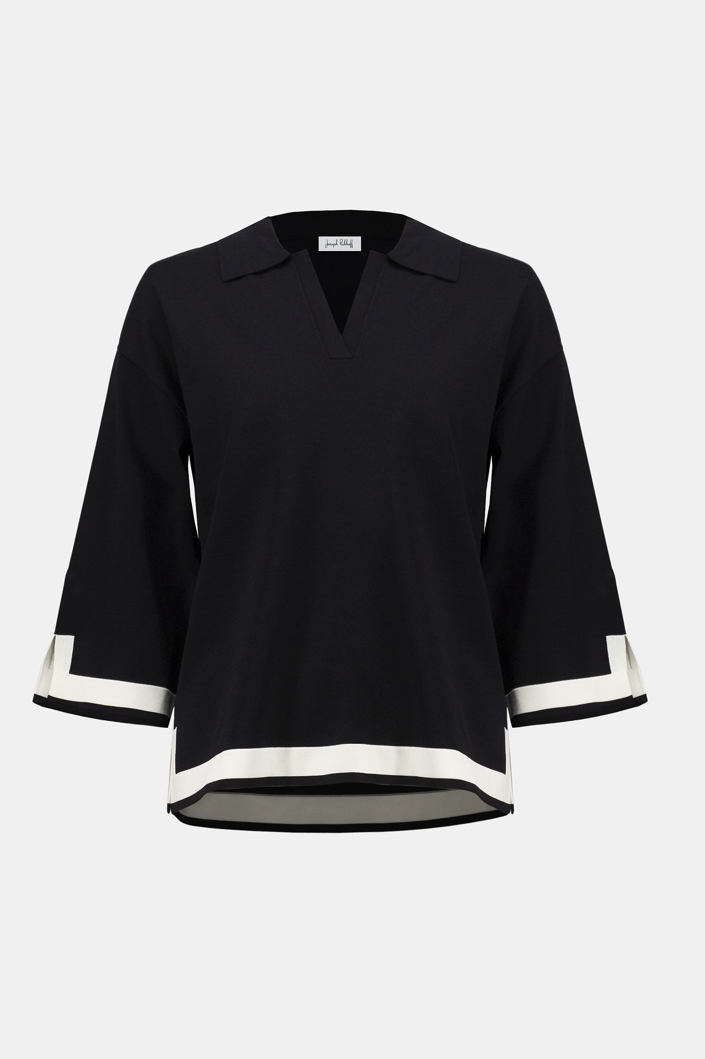 Black blouse with white trim on a white background