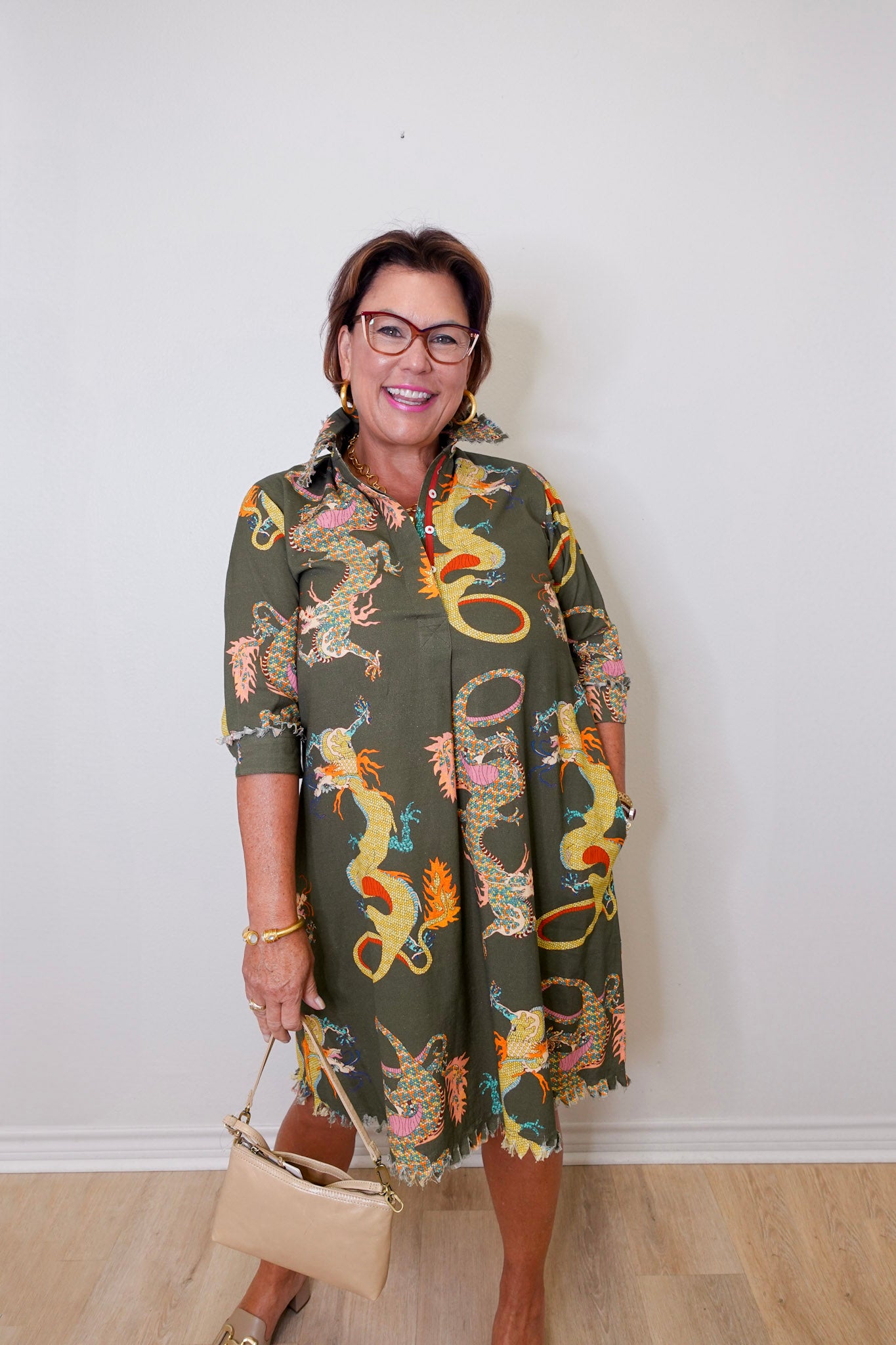 Woman wearing a patterned dress with a plain background