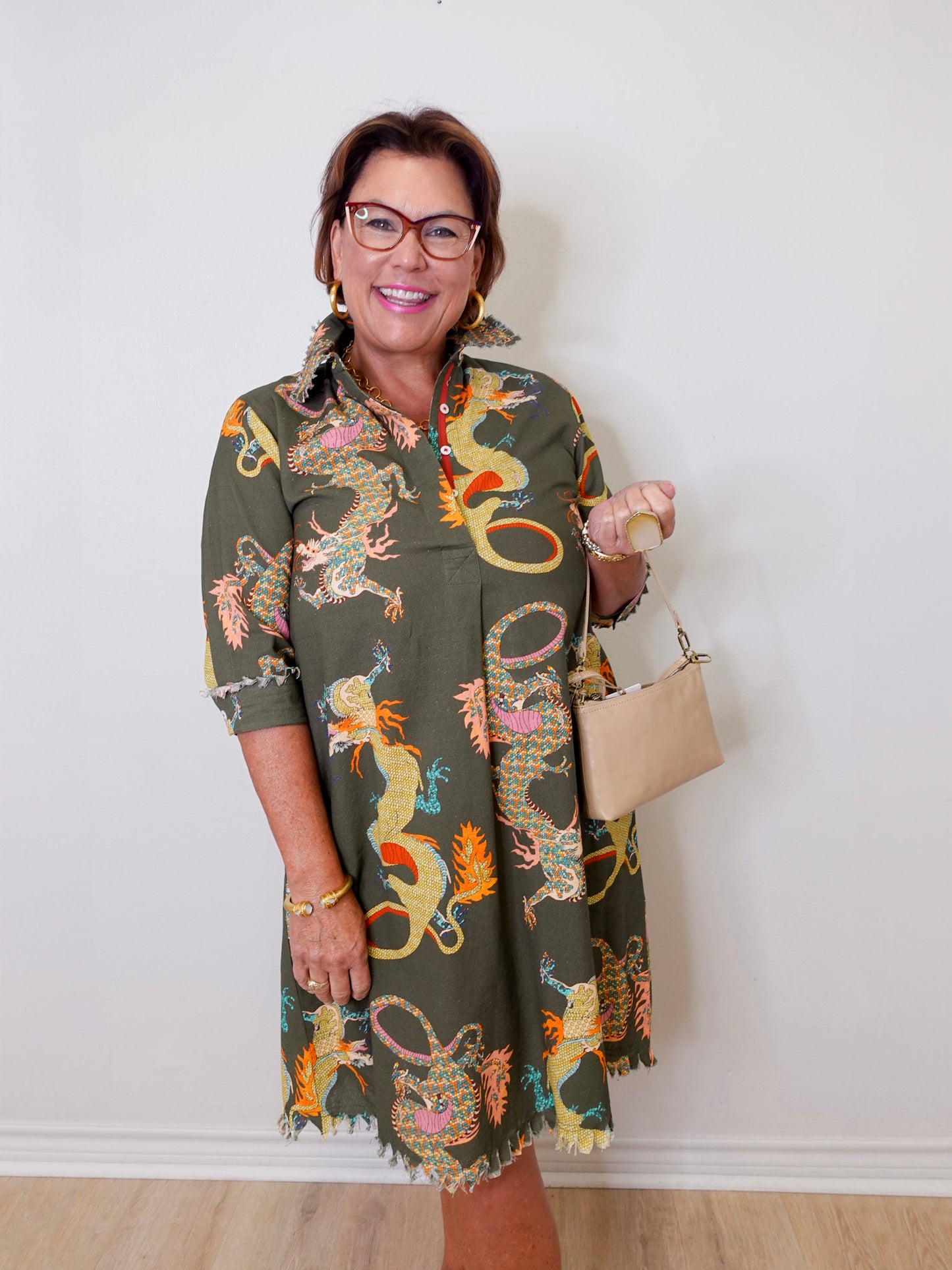 Woman wearing a patterned dress with a plain background