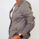 Person wearing a brown pinstripe blazer on a plain background