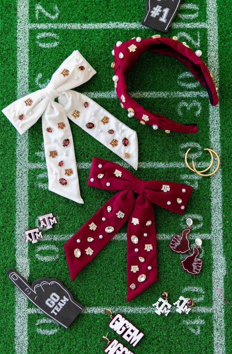 Accessories including headbands and hair bows on a football field background