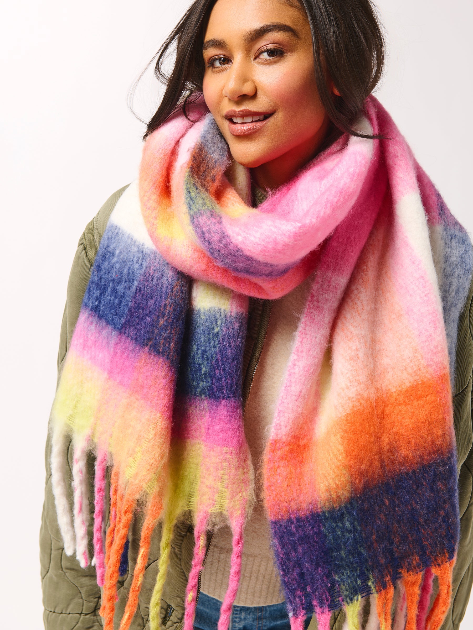 Person wearing a colorful striped scarf on a white background