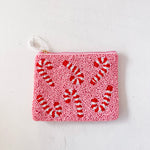 Pink pouch with red candy cane pattern on a white background
