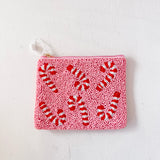Pink pouch with red candy cane pattern on a white background