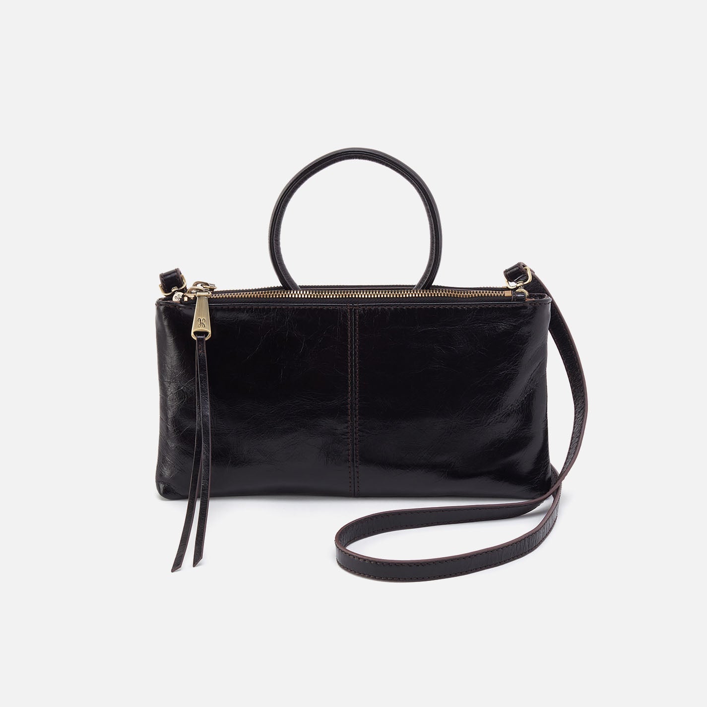 A black leather sable crossbody handbag with a shoulder strap and a zipper closure.