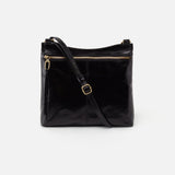 Black leather handbag with a shoulder strap on a white background