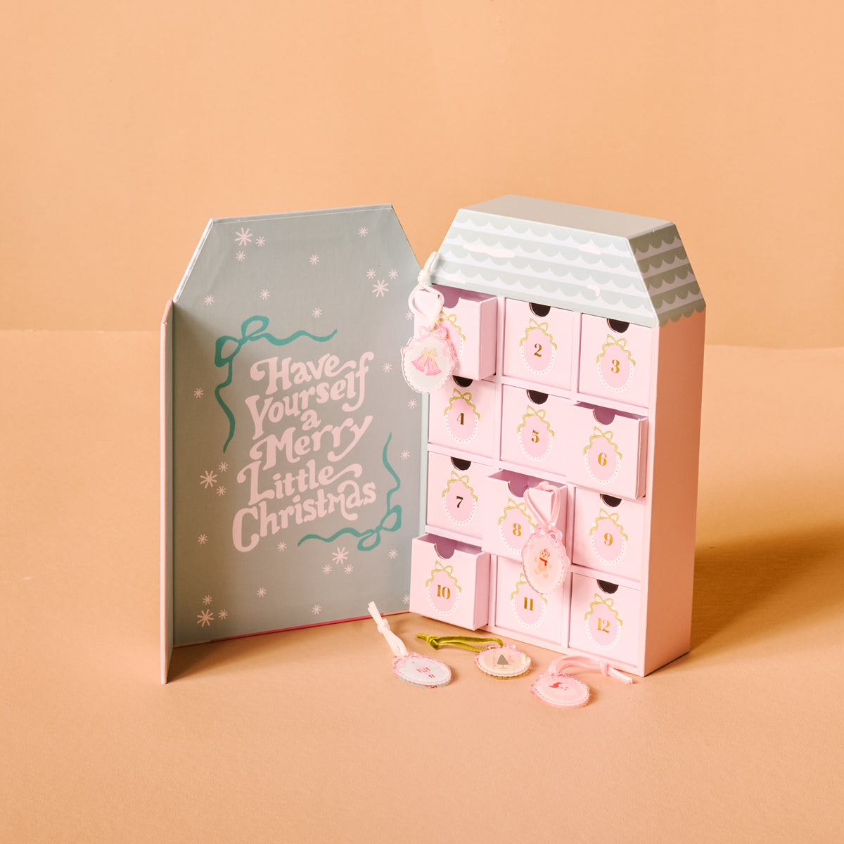 Pink advent calendar with decorative elements on a beige background