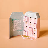 Pink advent calendar with decorative elements on a beige background