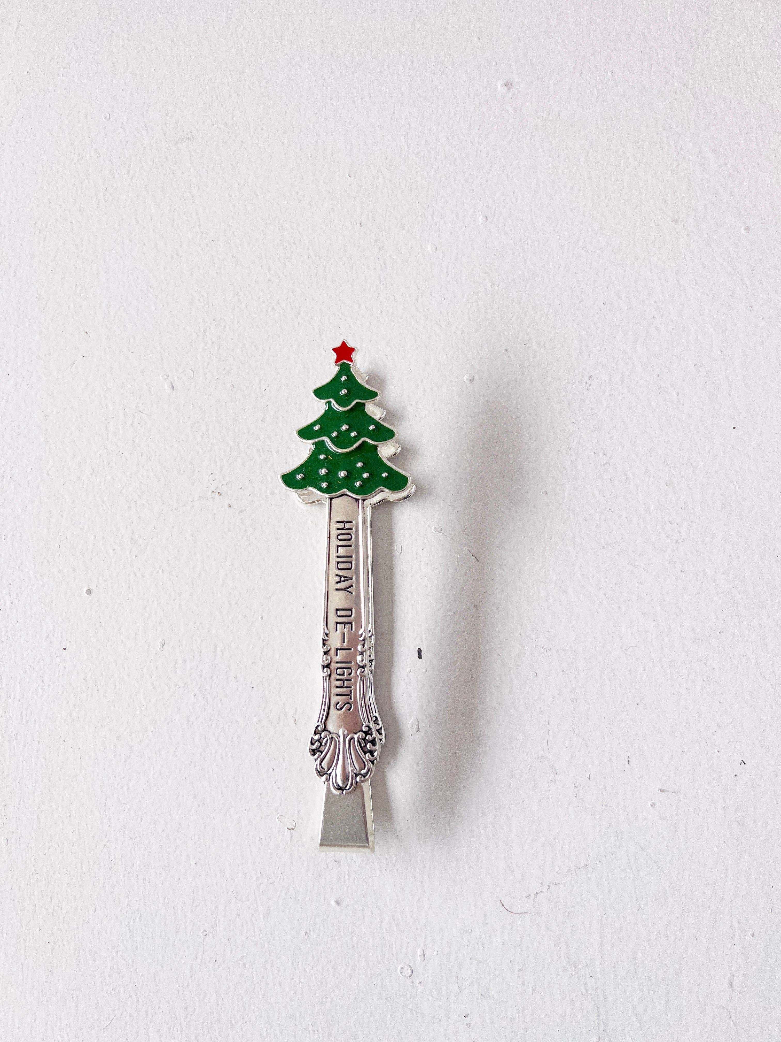Decorative spoon with a Christmas tree design on a white background