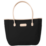 Black tote bag with beige handles and trim on a transparent background