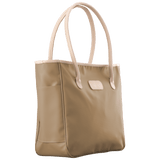 Beige tote bag with white handles on a black background
