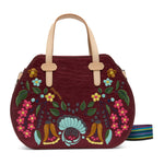 Handbag with floral embroidery and colorful strap on a white background