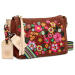 Brown handbag with colorful floral embroidery on a white background