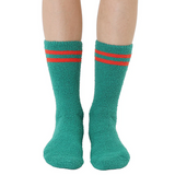Green socks with red stripes worn by a person on a white background
