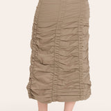 Beige ruched skirt worn by a person on a white background