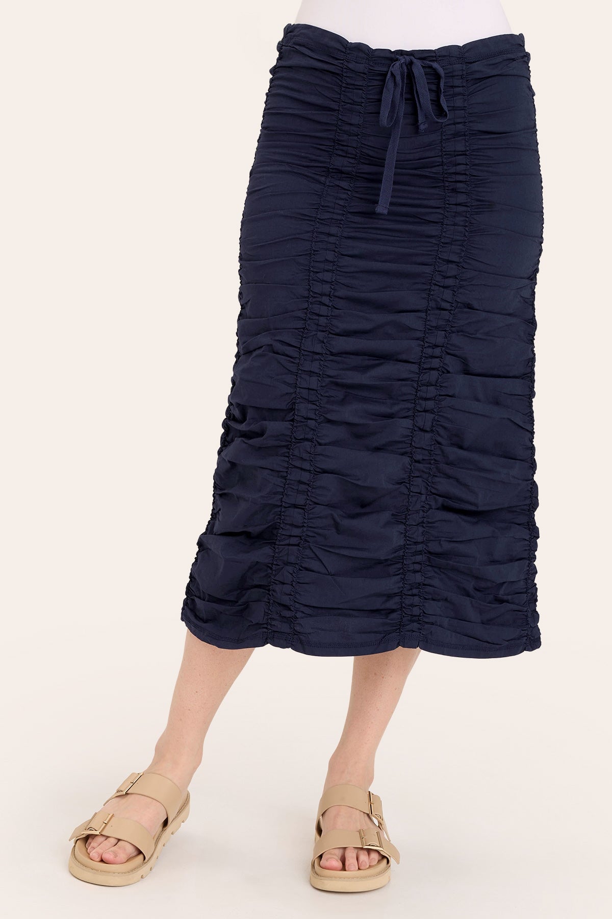 Navy blue ruched skirt worn by a person on a white background