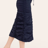 Navy blue ruched skirt worn by a person on a white background