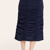 Navy blue ruched skirt worn by a person on a white background