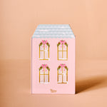 Pink gift box with window illustrations and bows on a beige background