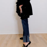 Person wearing a black outfit with a white background