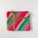 Colorful beaded pouch with a bow on a white background