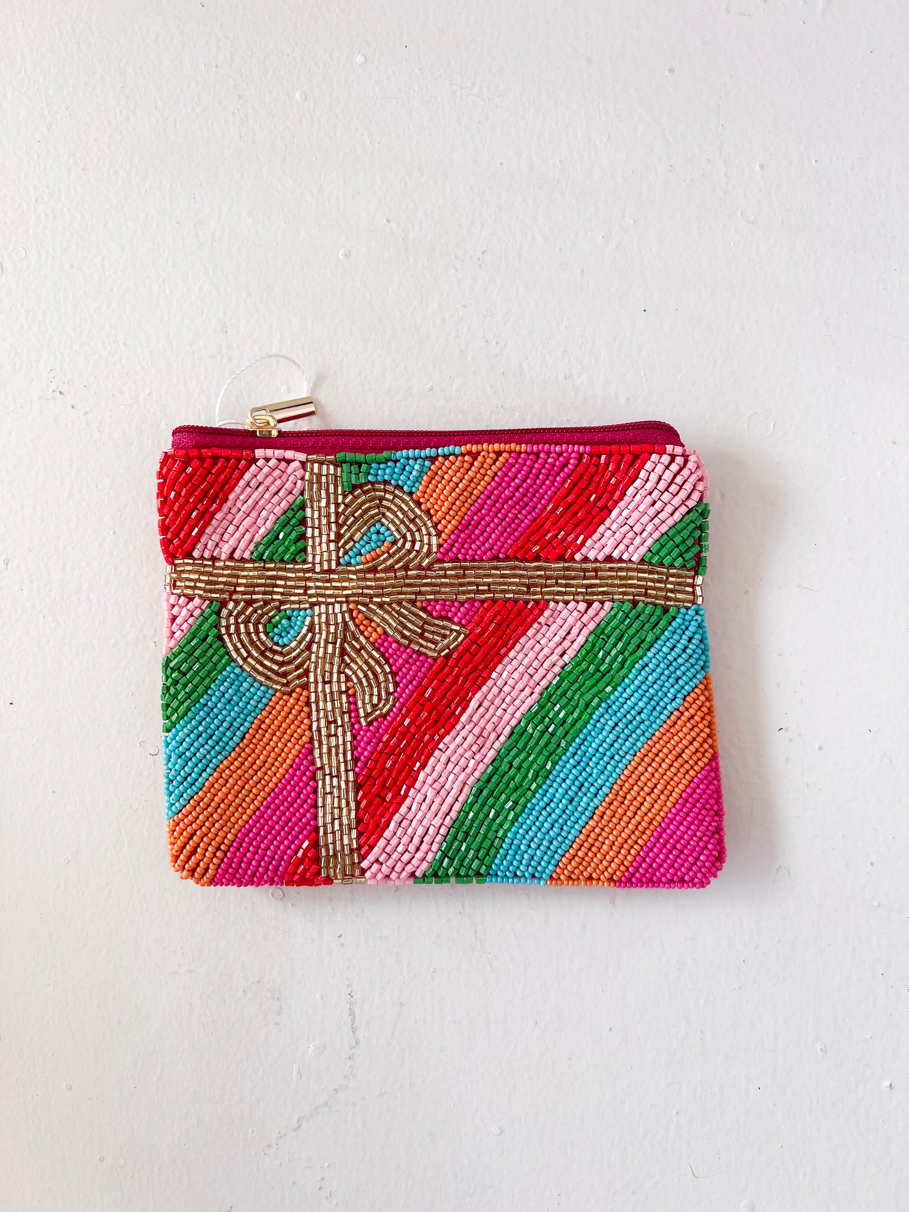 Colorful beaded pouch with a bow on a white background