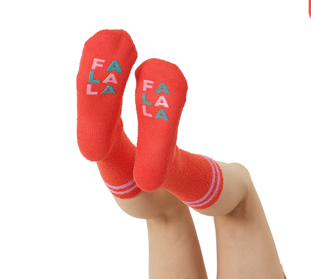 Red socks with 'FA LA LA' text on a white background