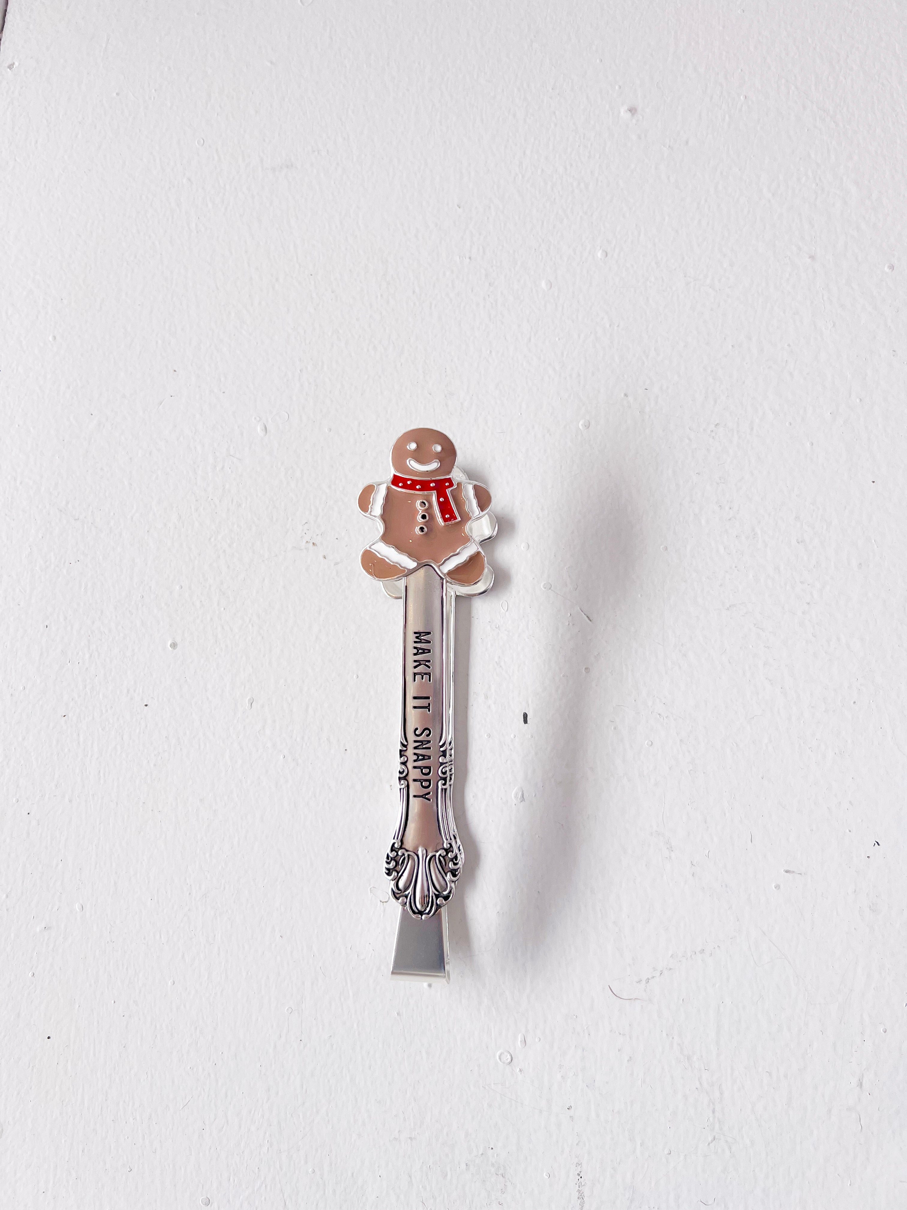 Gingerbread man-themed spoon on a white background