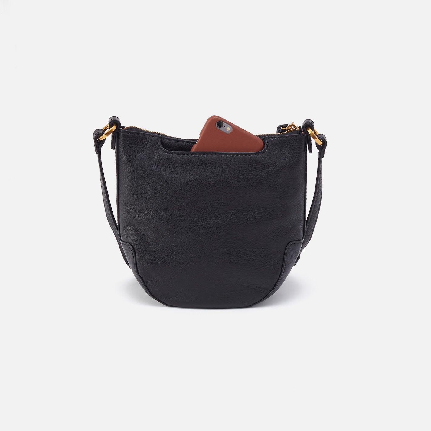 Black handbag with a brown phone case on a white background