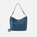 Blue handbag with a strap on a light gray background