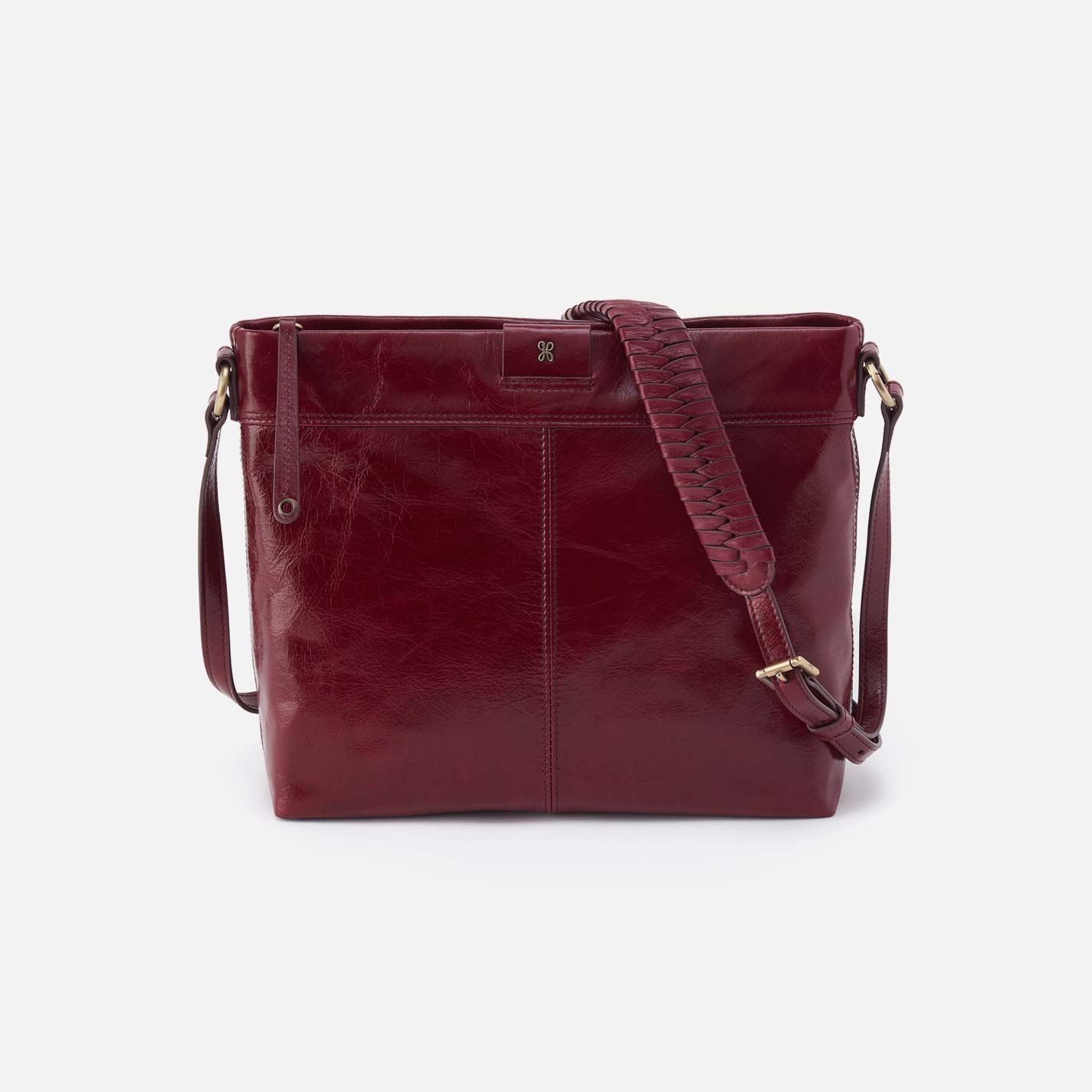 Red leather handbag with a strap on a white background
