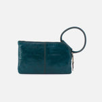 Teal leather clutch with a wrist strap on a light gray background