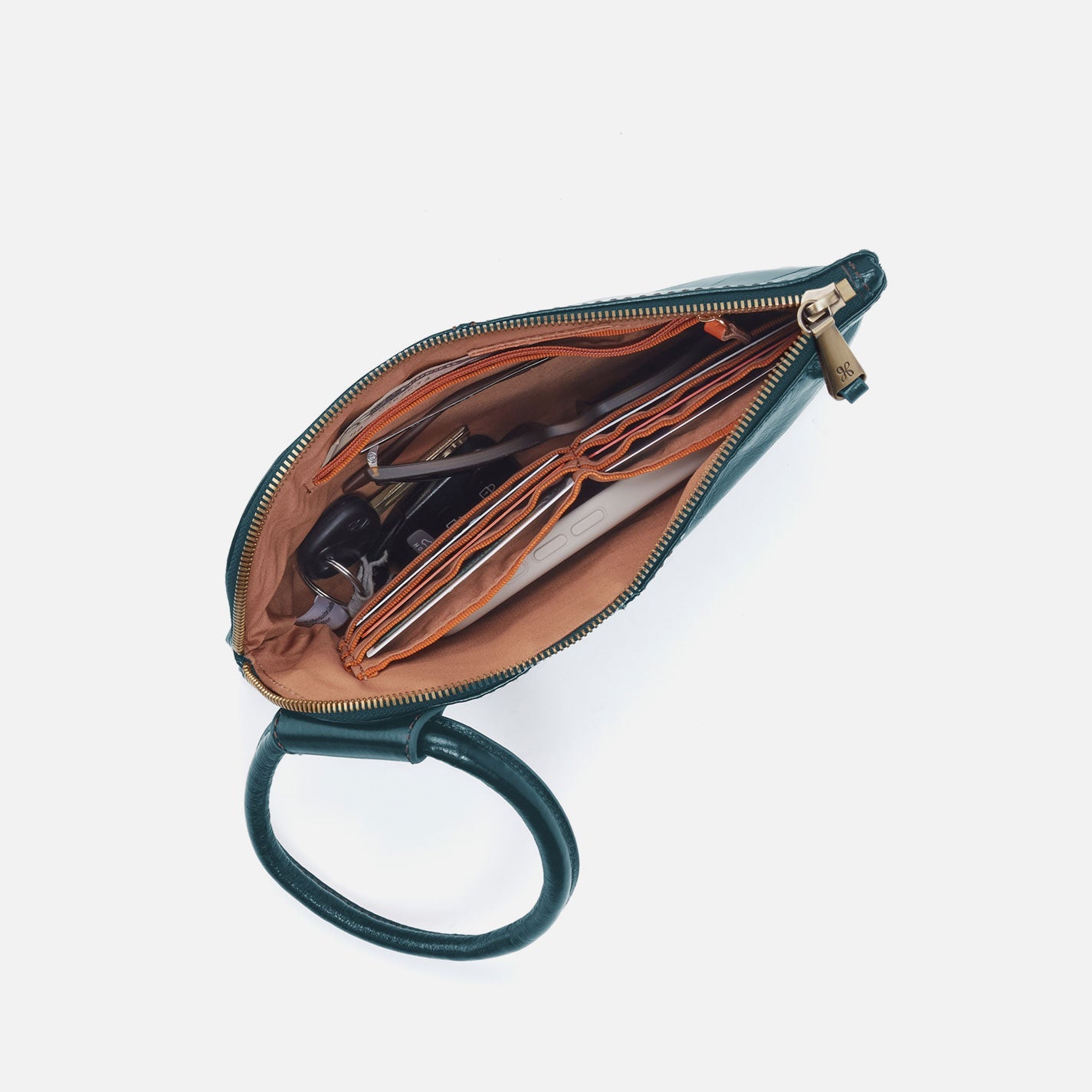 Green leather clutch with open interior on a white background