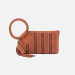 Brown leather clutch with woven design and tassel on a white background