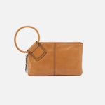 Brown leather clutch with ring handle on a light gray background