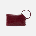 Red leather clutch bag with a keyring on a white background