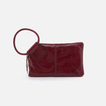 Red leather clutch bag with a handle on a white background
