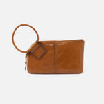 Brown leather clutch with a round handle on a white background