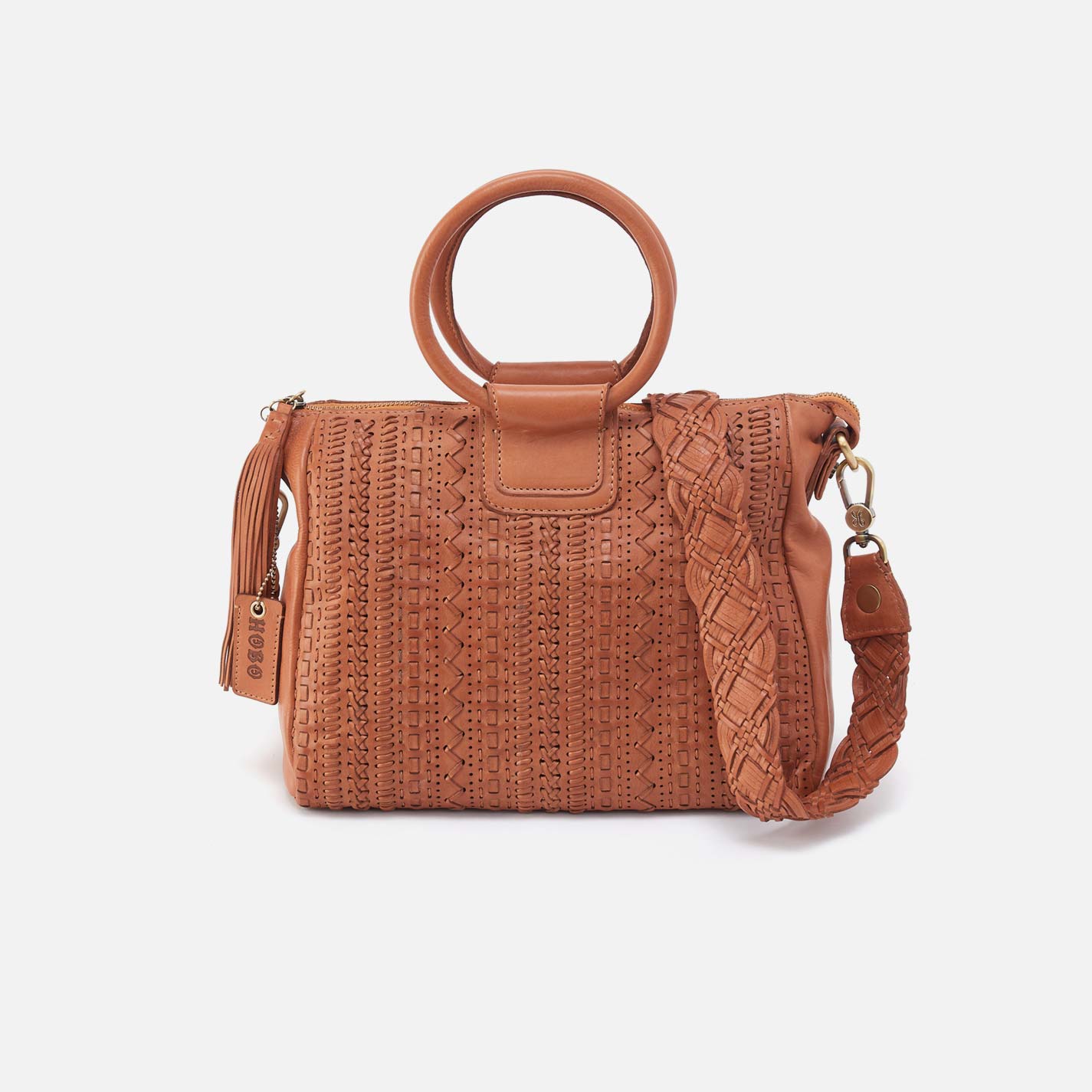 Brown woven handbag with circular handle on a white background