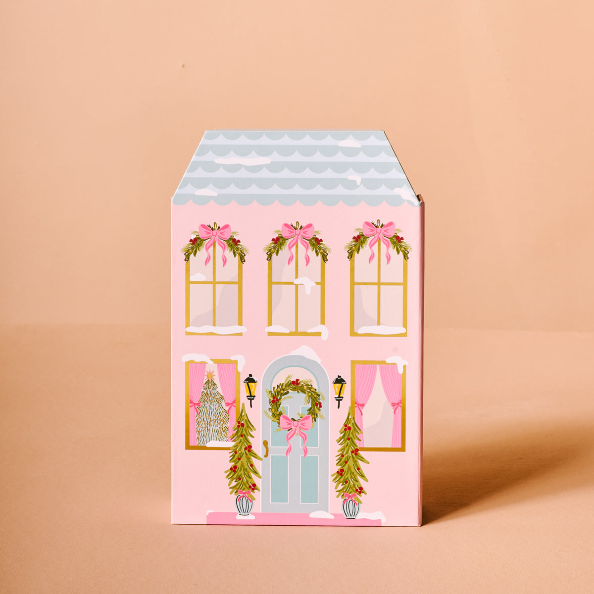 Decorative box with a house design on a beige background