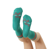 Teal socks with 'Jingle All The Way' text on a white background