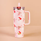 Pink tumbler with red bird design on a beige background