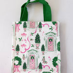 Small tote bag with festive design featuring doors, wreaths, and ribbons on a white background