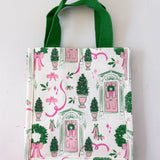Small tote bag with festive design featuring doors, wreaths, and ribbons on a white background